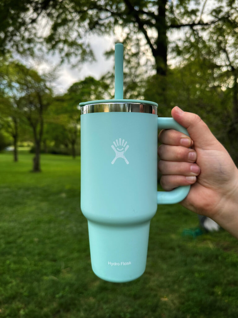 teal Hydro Flask with a straw outdoors 