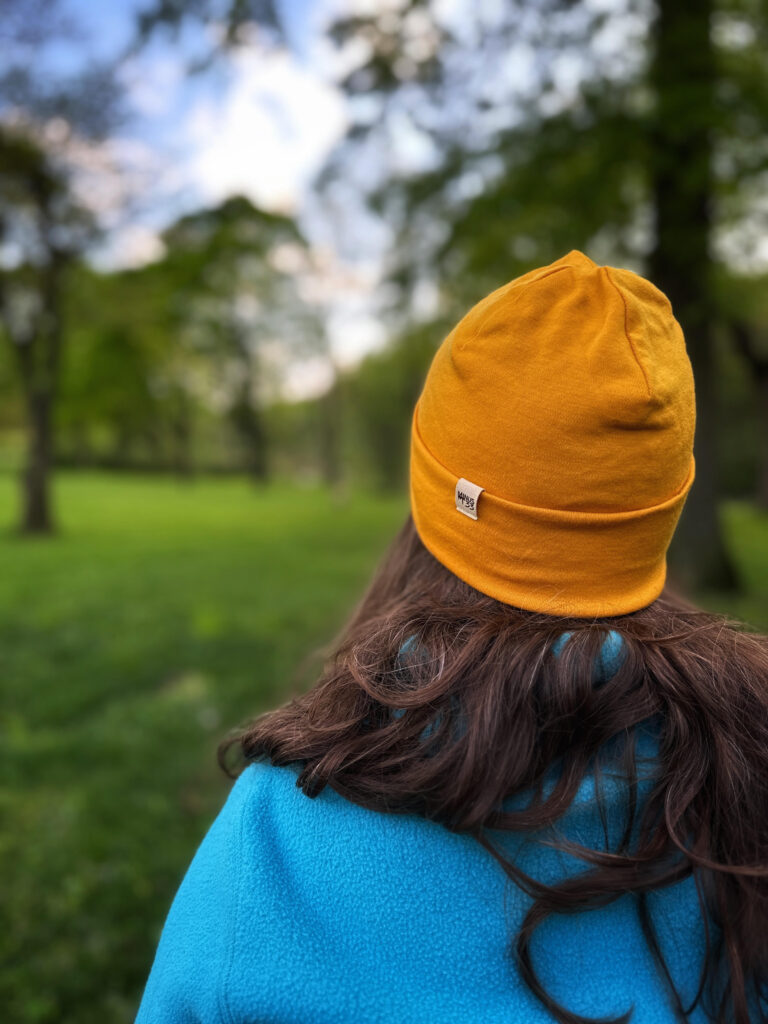 yellow Minus 33 merino wool beanie on a woman outdoors 