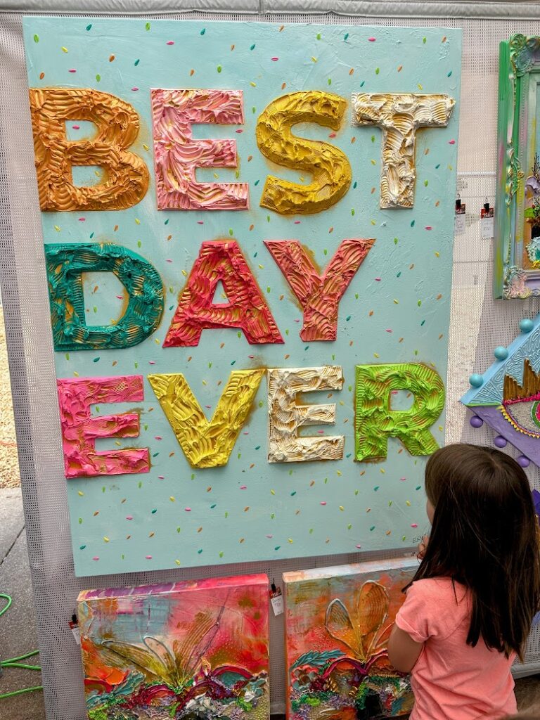 a girl looking at art at ArtsFest in Springfield, Missouri