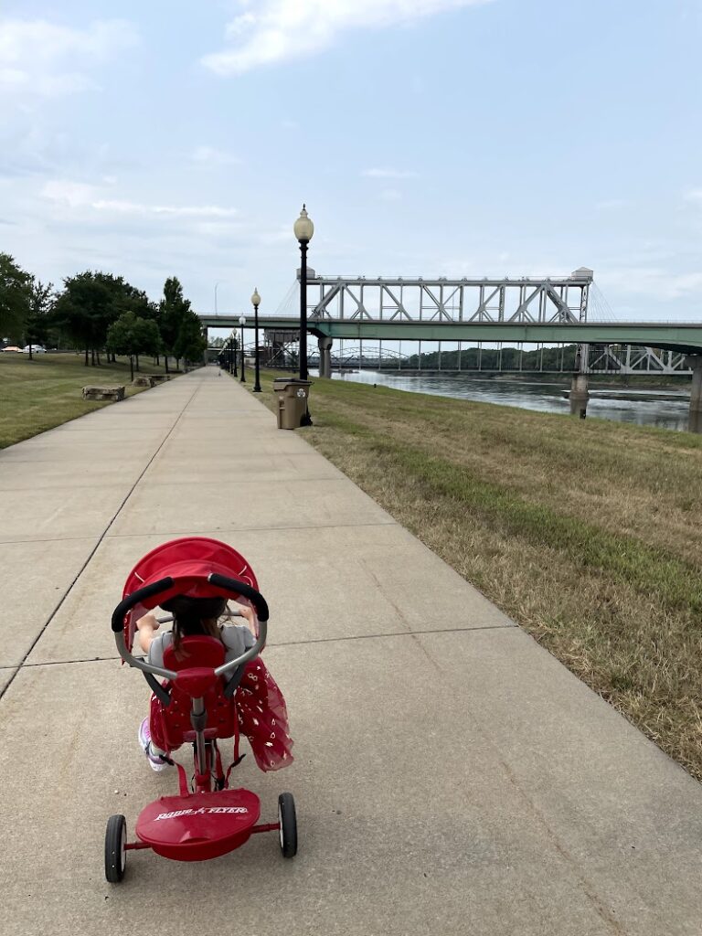 a girl on her tricycle biking at Berkley Riverfront Park