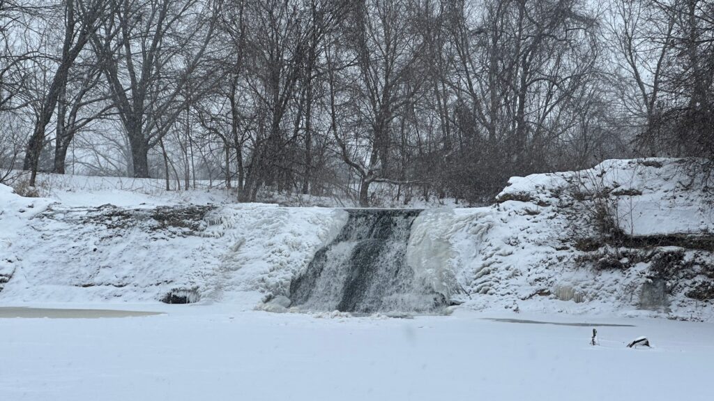 Cedar Creek Waterfall partially frozen in the snow at Lake Olathe