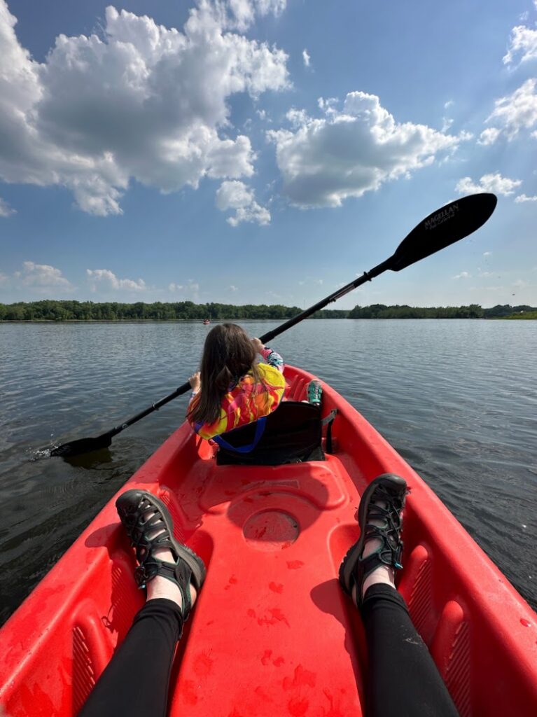 a girl kayaking on a lake