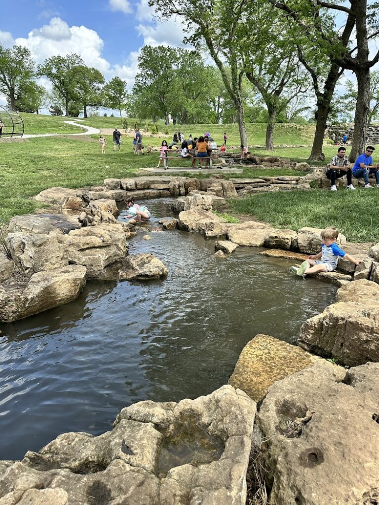 Children playing in the creek at Lake Olathe Splash Pad