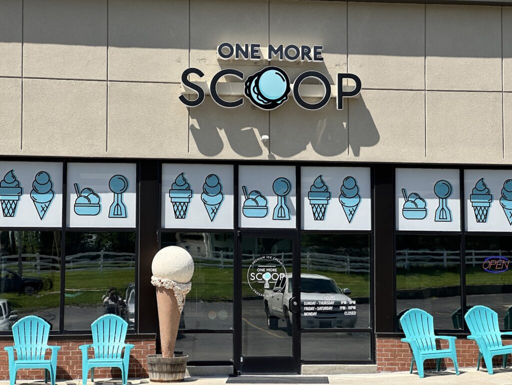 the front of One More Scoop ice cream shop with a large ice cream cone