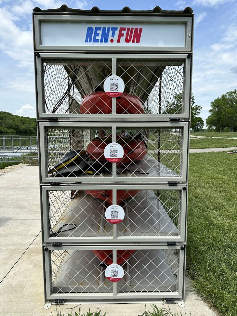 A cage with kayaks inside for self-service kayak rental at Lake Olathe