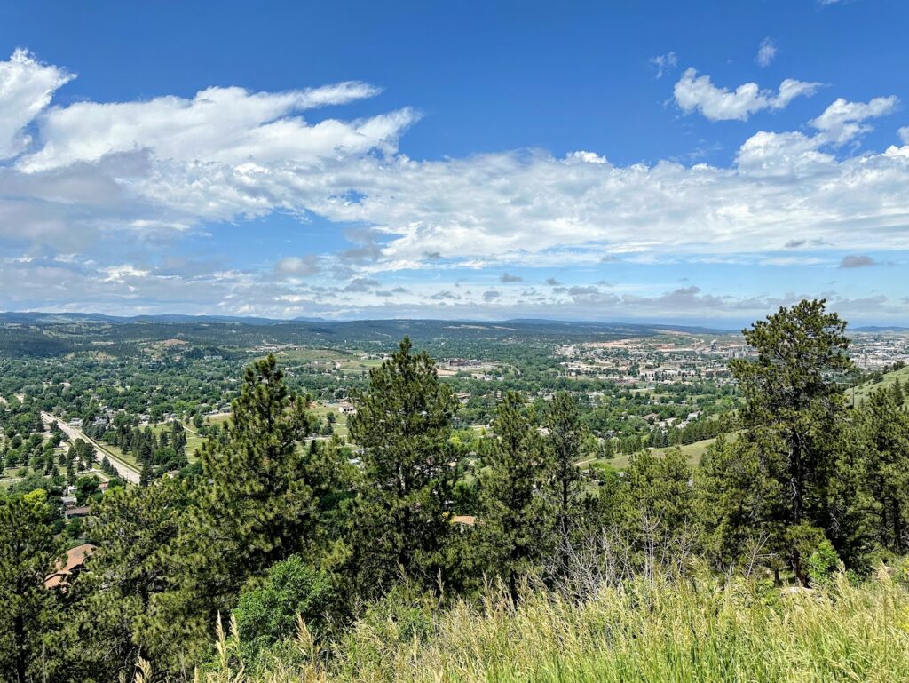 a view of rapid city and the surrounding hills from above