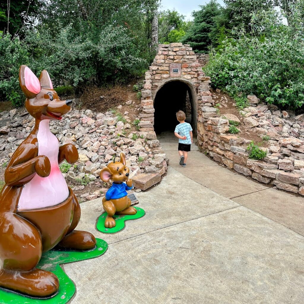 a boy walking through a tunnel at Storybook Island 