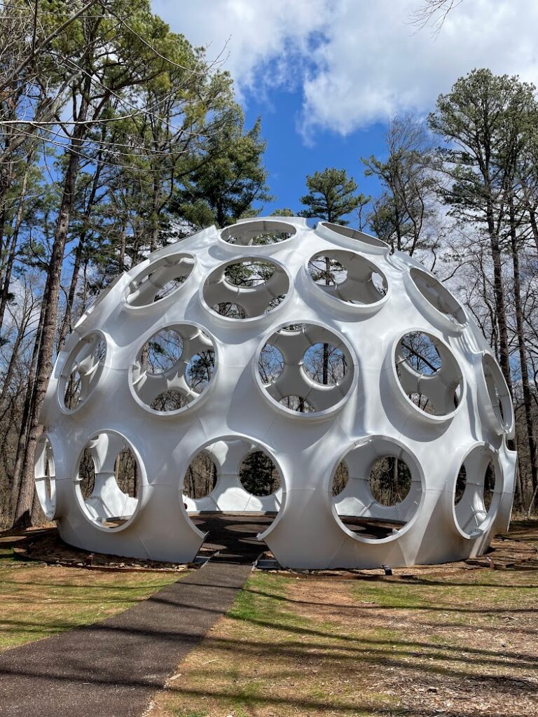 A large white dome with holes in it on the hiking trails at Crystal Bridges in Bentonville, weekend getaway from Kansas City