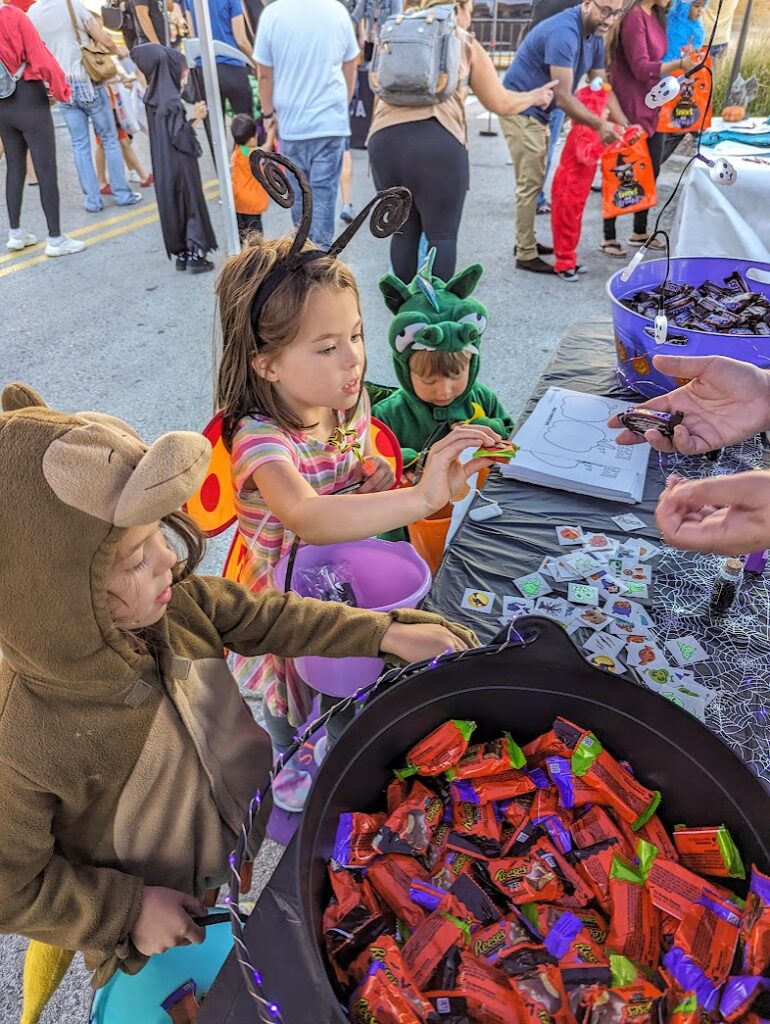 kids getting candy at a trunk or treat in Kansas City