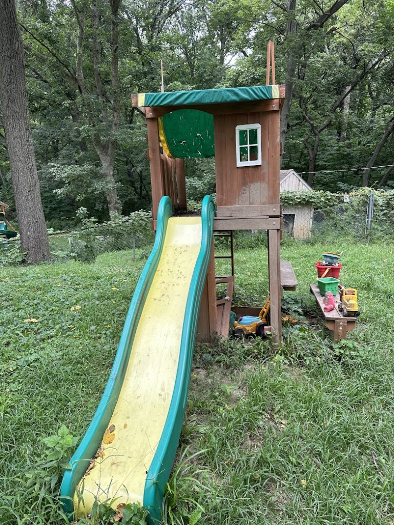 An old swing set that is falling apart