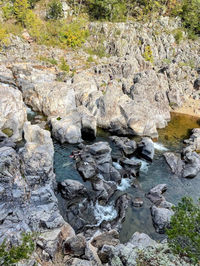 An overhead view of Johnson Shut Ins from above with water flowing over big rocks, Arcadia Valley, Missouri