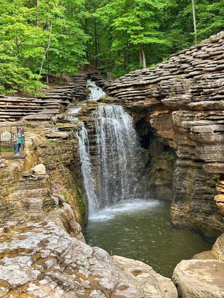 Kids looking at a waterfall at Lost Cave Canyon near Branson, Missouri, a Midwest Fall Trip 