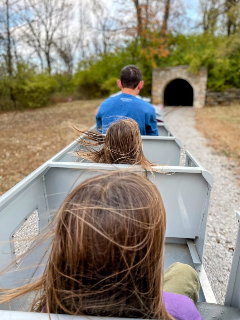 Two girls riding on a miniature train in Kansas City 