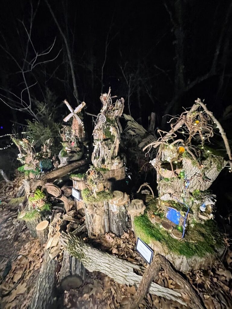 A fairy house constructed from logs, moss, and twigs at the Luminary Walk at the Overland Park Arboretum, Christmas in Kansas City