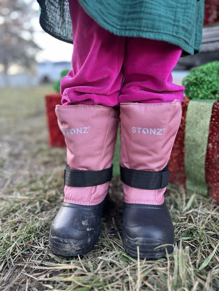 A girl wearing pink Stonz boots