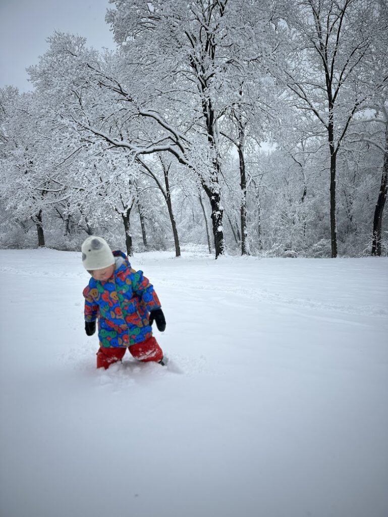 A boy walking in the snow 