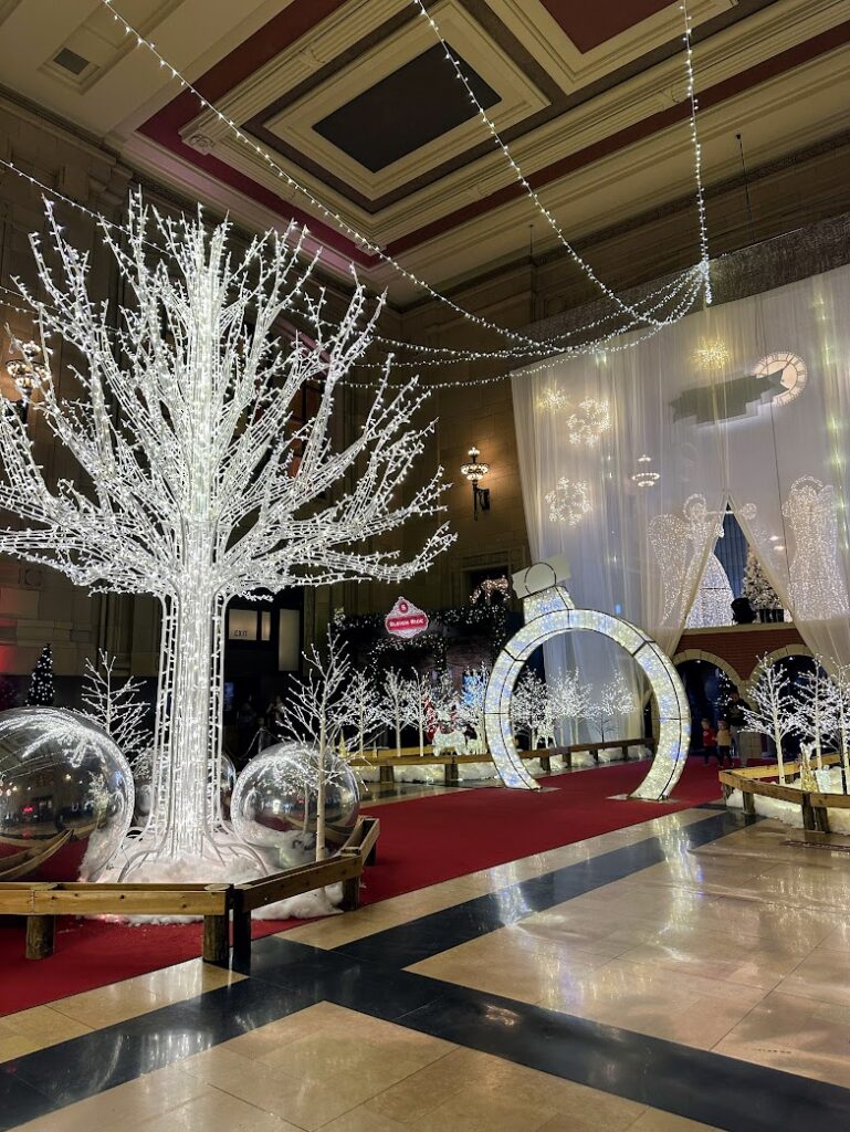 The entry way with beautiful lit trees and ornaments to Holiday Reflections at Union Station in Kansas City