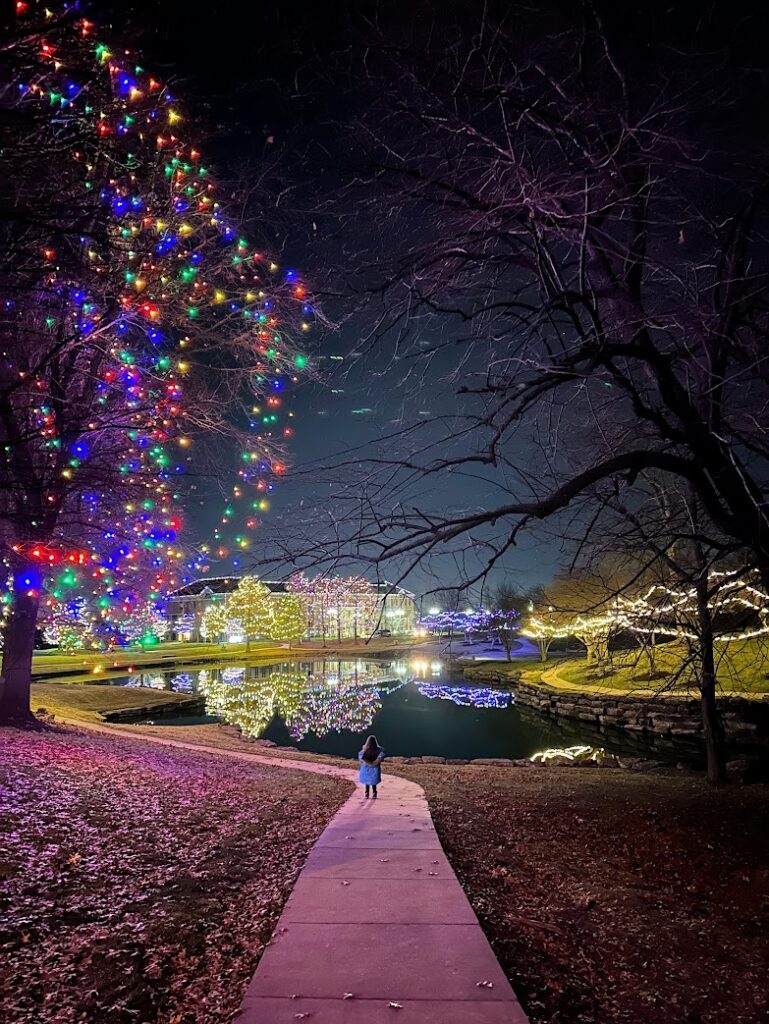 A girl walking among Christmas lights in Kansas City